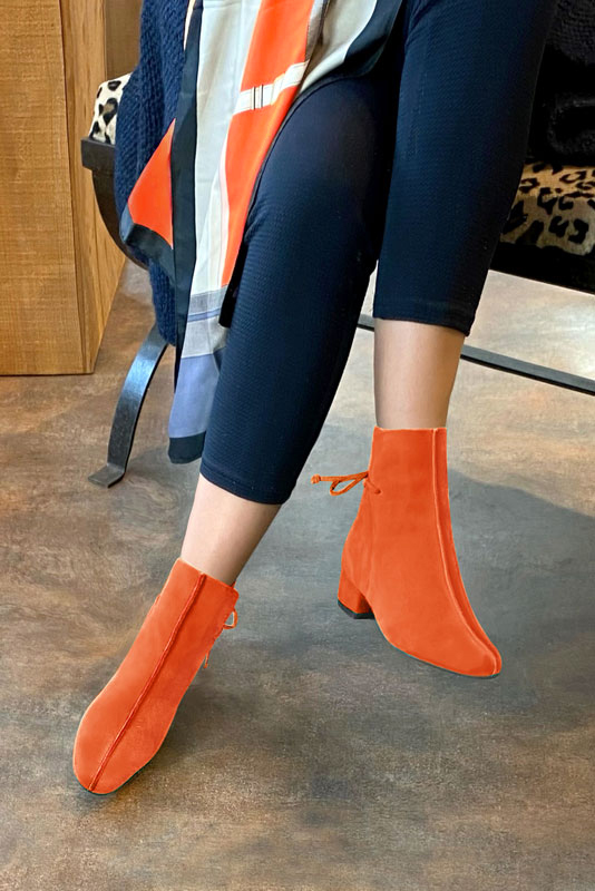 Clementine orange women's ankle boots with laces at the back. Round toe. Low block heels. Worn view - Florence KOOIJMAN
